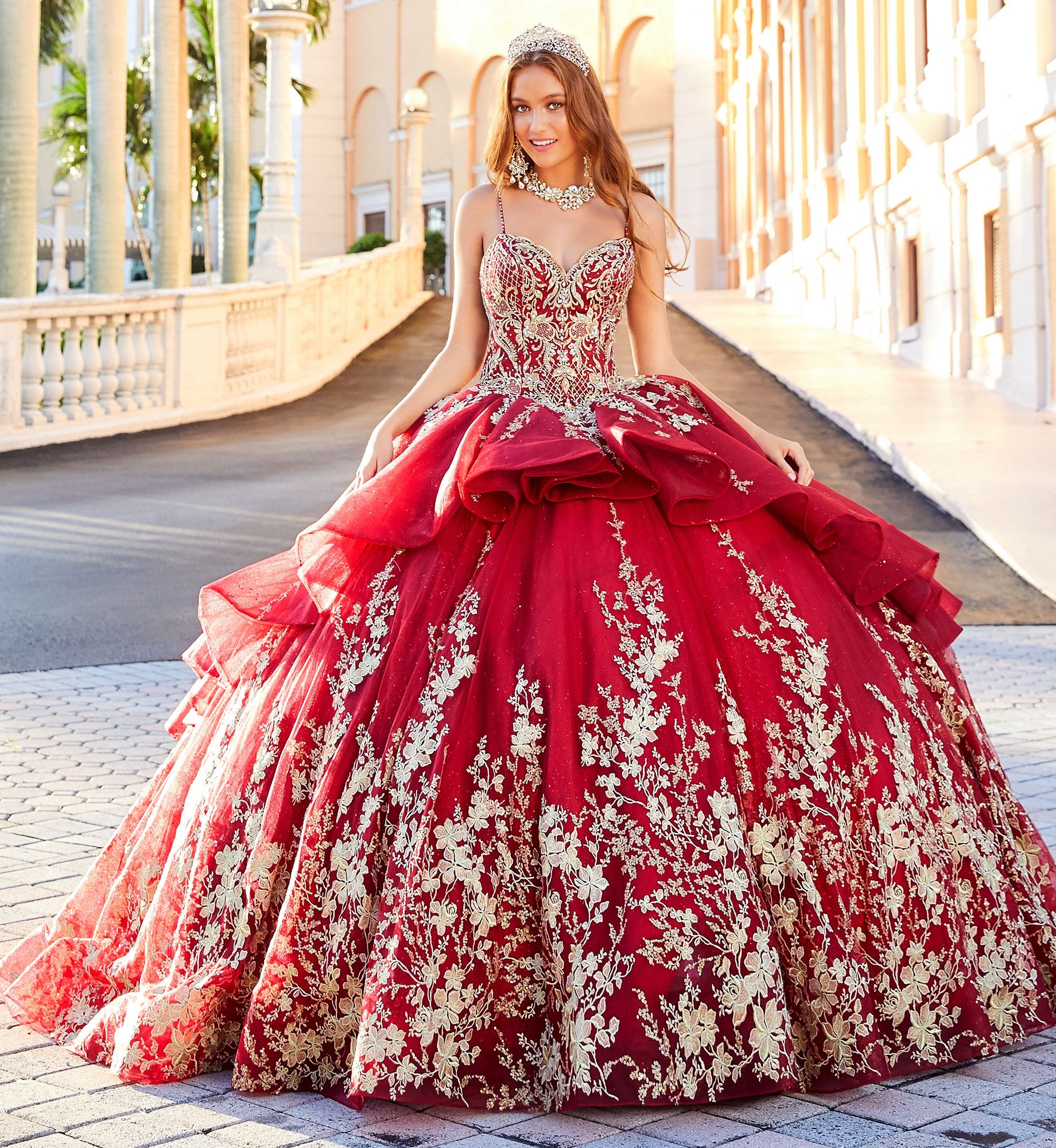 Brunette model in red and gold quinceañera dress