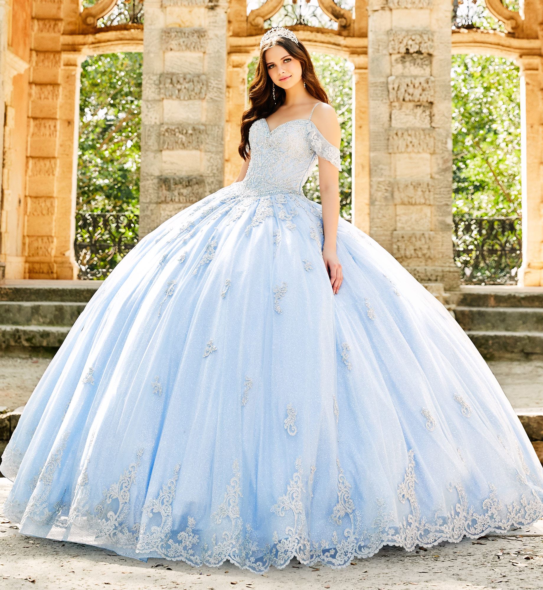 Brunette model in baby blue quinceañera dress with lace embroidery