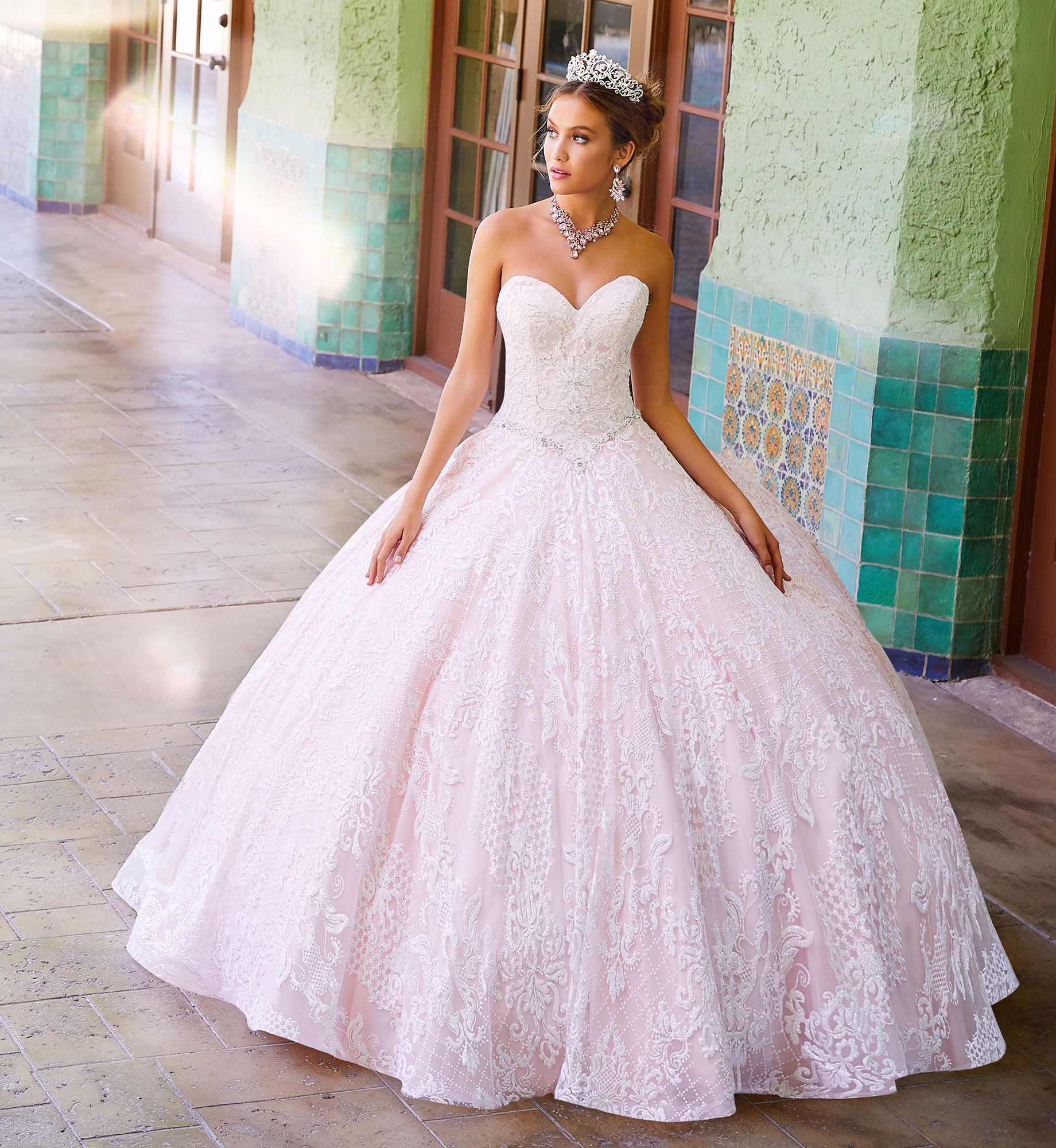 Brunette model in pale pink strapless quinceañera dress