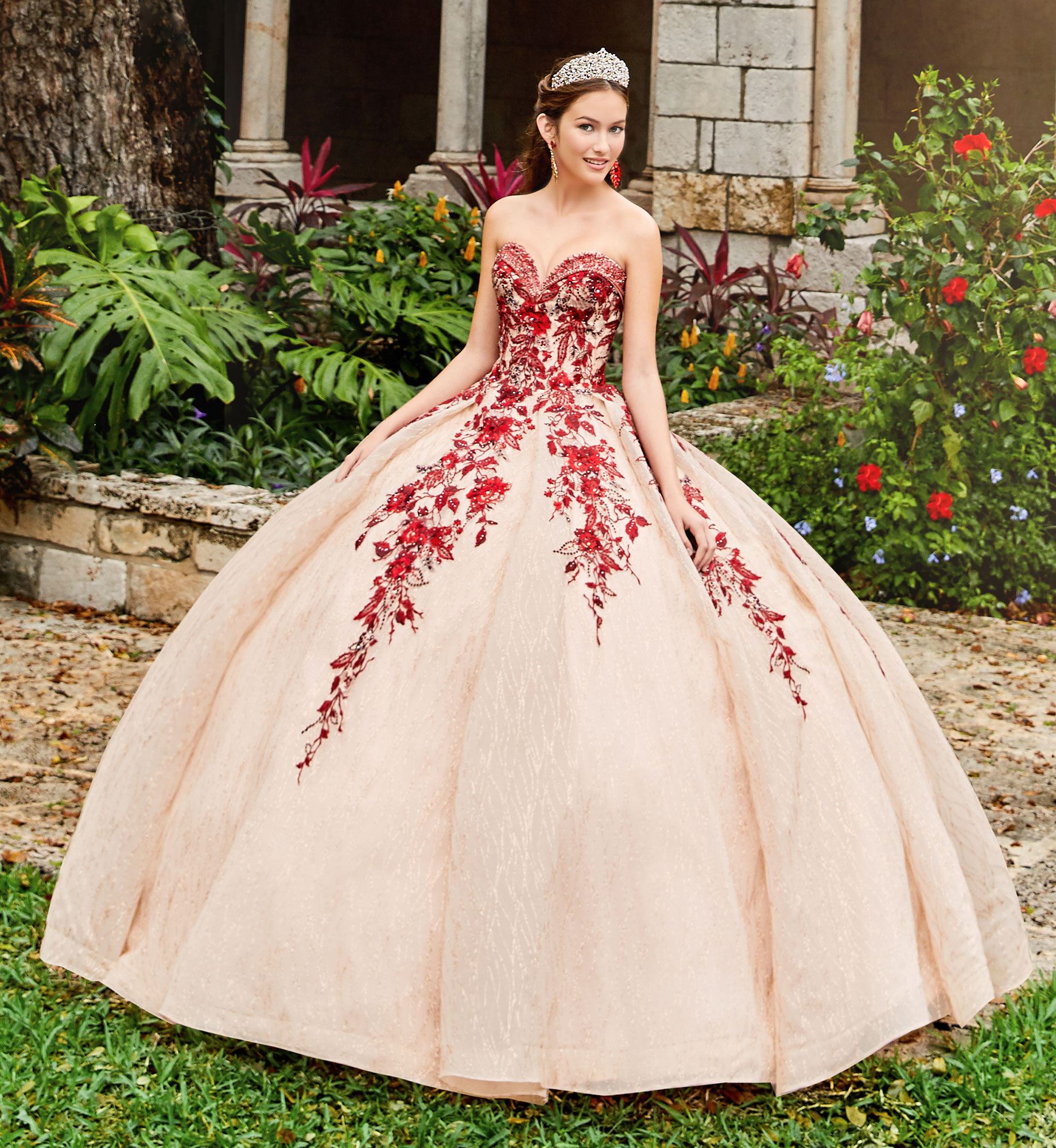 Brunette model in red and gold strapless quinceañera dress